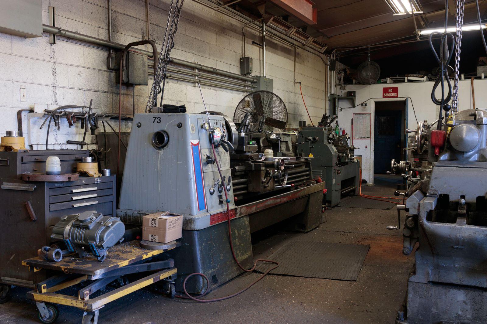 Manual lathes lined up on a machine shop floor