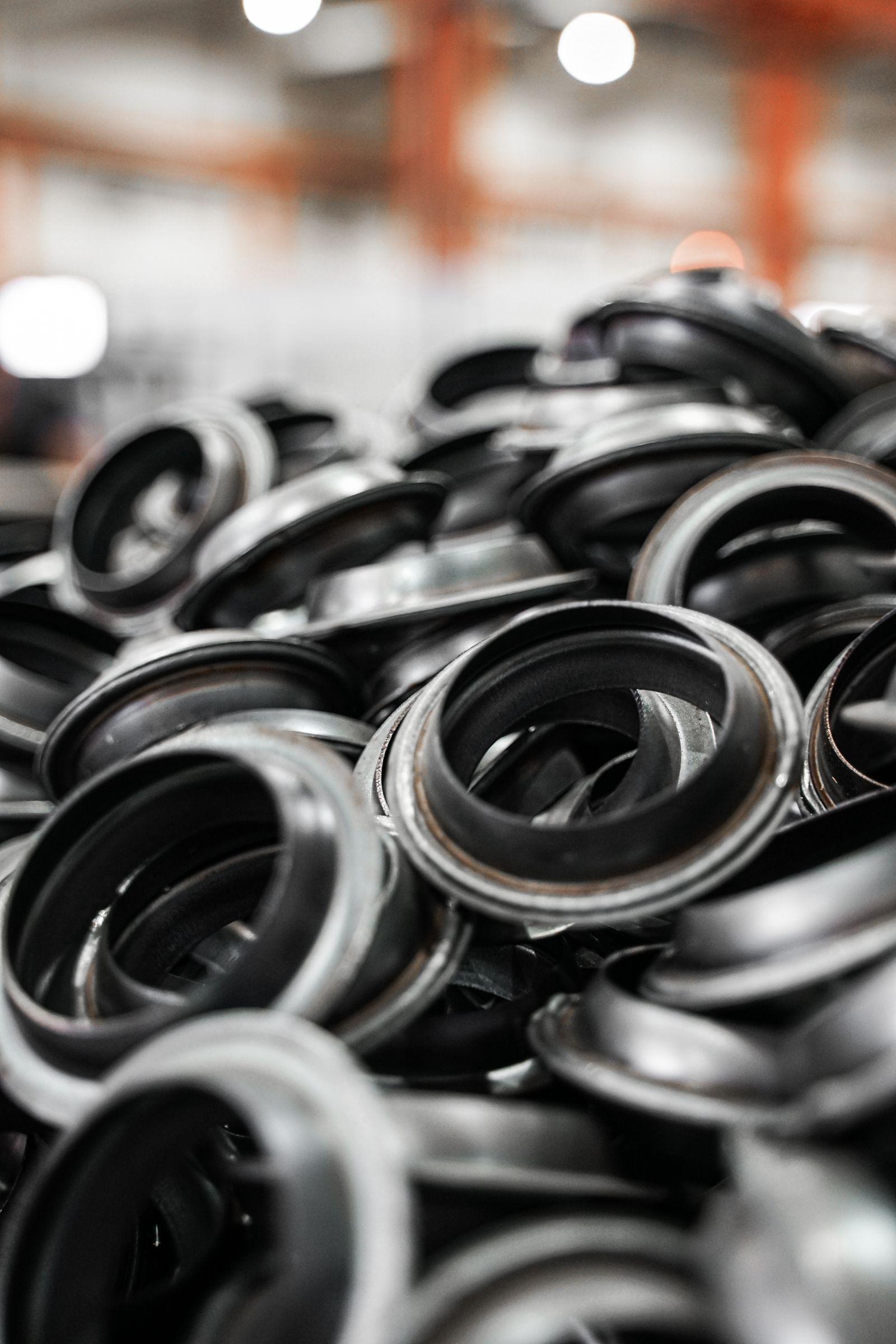 Pile of machined ring and seal components on a factory floor