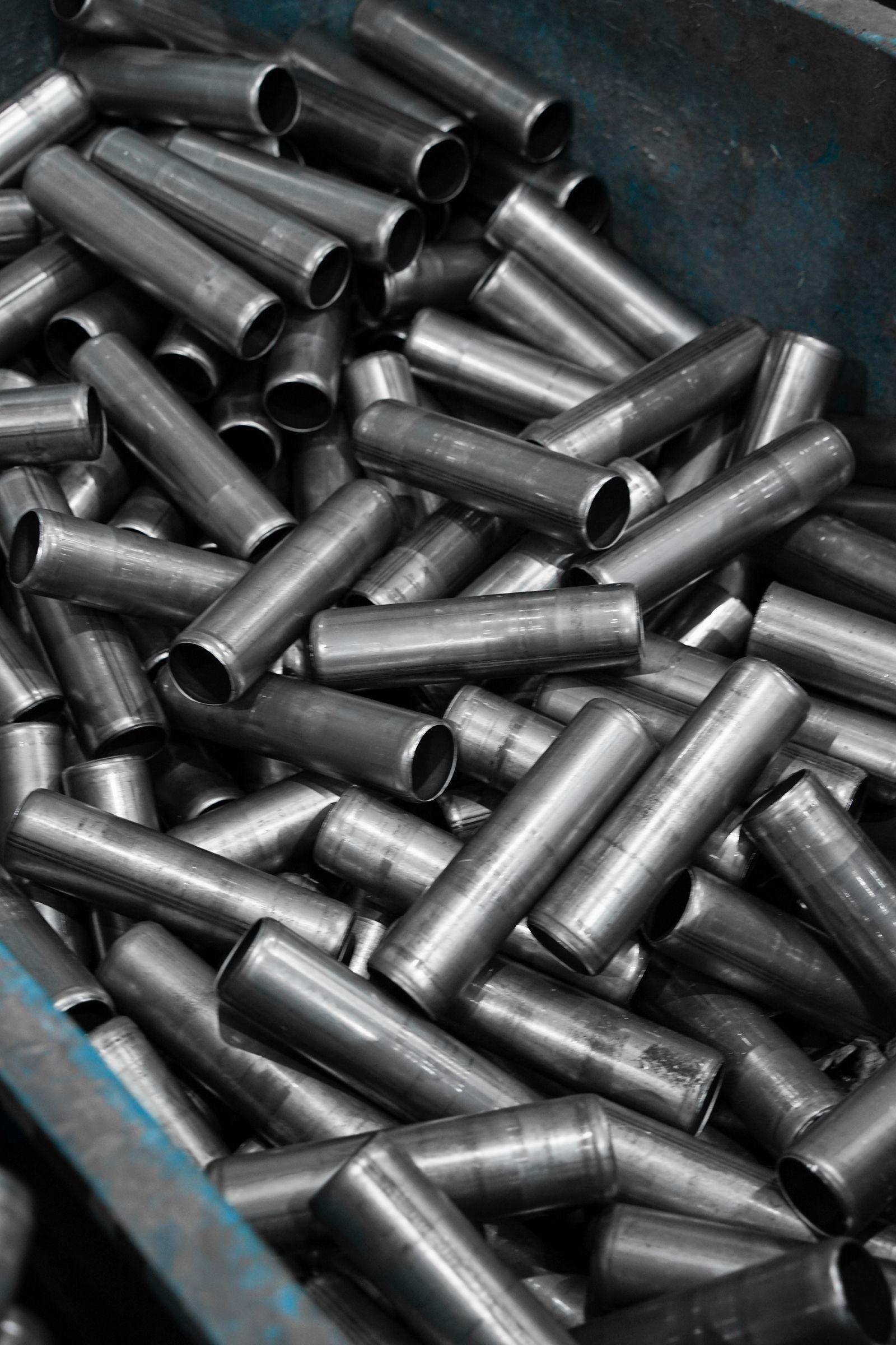 Bin of turned steel bushings and tubular components