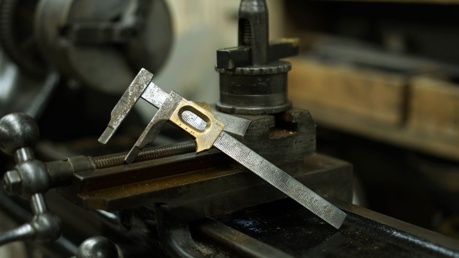 Vernier caliper resting on the compound slide of a metal lathe